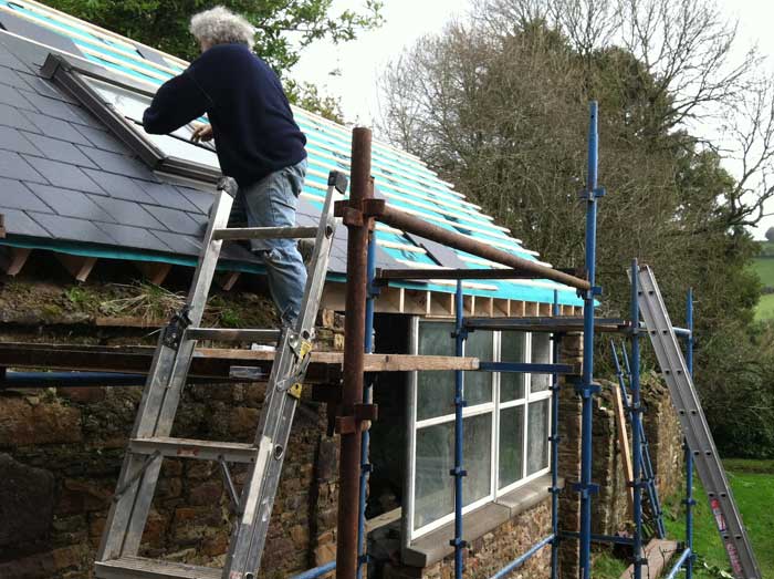 Mike installing a skylight window in the roof